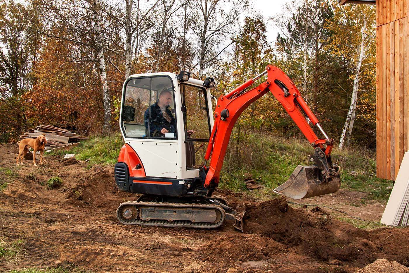 Mini Excavator digging trench